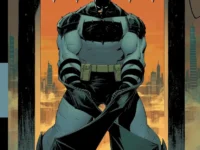 Paperback graphic novel Absolute Batman Vol. 1 The Zoo displayed on a wooden shelf with cover facing forward