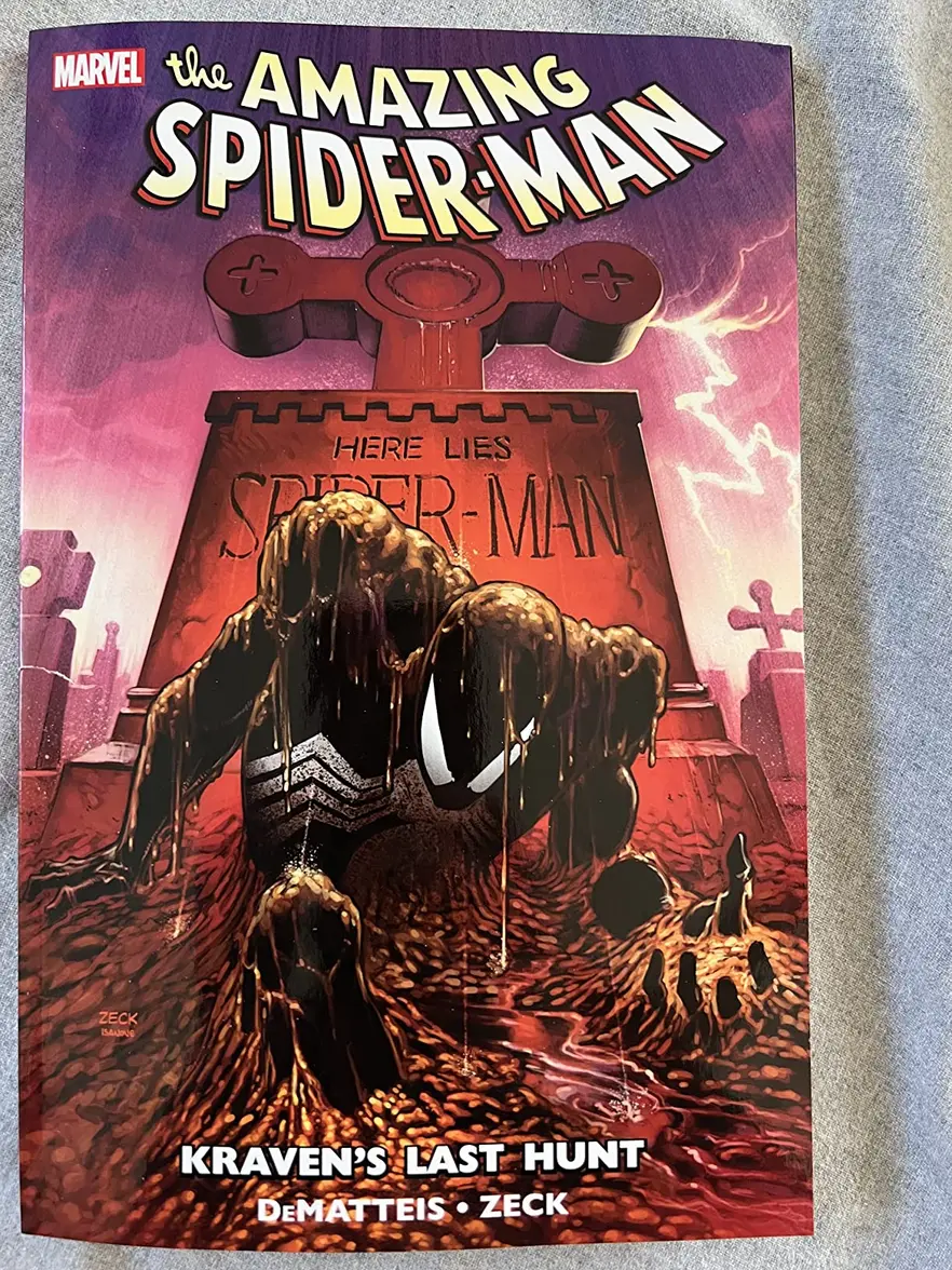 Spider-Man Kraven's Last Hunt Paperback spine visible on a bookshelf with other comic books