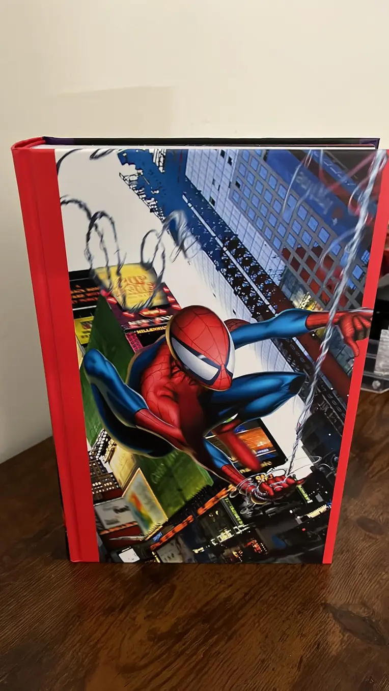 Ultimate Spider-Man Omnibus Vol. 1 open to an interior page on a wooden table