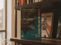 "Batman The Long Halloween" comic book displayed on a bookshelf in golden hour light.